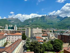 a view of a city with mountains in the background at Art & Lake Apartment in Lecco