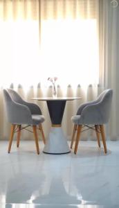 two chairs and a table in a room at Maarif elite suites in Casablanca