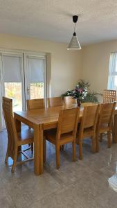 a wooden dining room table with wooden chairs and a table at Cumberland in Ballycastle