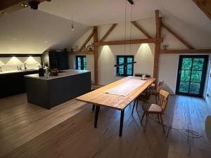 a large kitchen with a wooden table in a room at Buchmühle in Niederdorla