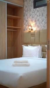 a bed with white sheets and pillows in a room at Maarif elite suites in Casablanca