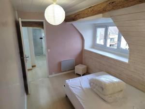 a bedroom with a white bed and a window at Le panoramique centre ville & RER 10 min in Étampes