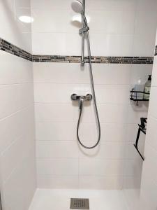 a shower in a white tiled bathroom at Le panoramique centre ville & RER 10 min in Étampes +38 photos