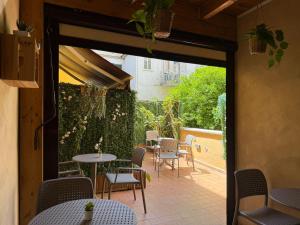 a patio with tables and chairs in a restaurant at Chiaia Suites in Naples
