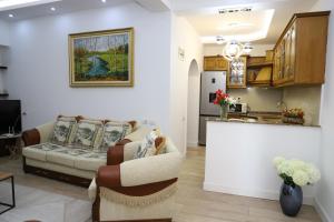 a living room with a couch and a kitchen at Apartment Countryside in Velabishti