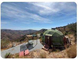 a green dome tent sitting on top of a hill at PinoPerdido Olías Málaga in Málaga +13 photos