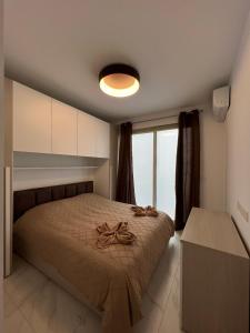 a bedroom with a bed with a rope on it at Marina Bay in Marsaskala