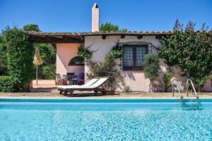 a house with a swimming pool in front of a house at Villa Fiori 3 in Is Molas  +19 photos