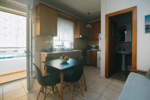 a kitchen with a table with chairs and a bowl of fruit on it at Iriana's Home in Kos