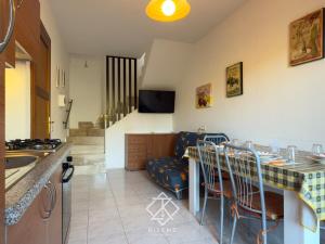 a kitchen with a couch and a table with chairs at Domus Vespro in Villasimius