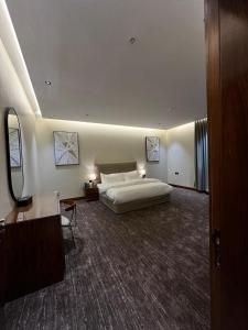a large bedroom with a large bed in a room at روز سويت RoSE SWEET in Riyadh +3 photos