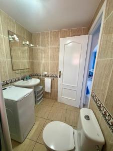 ein Badezimmer mit einer weißen Toilette und einem Waschbecken in der Unterkunft Blue Ocean in Costa Del Silencio