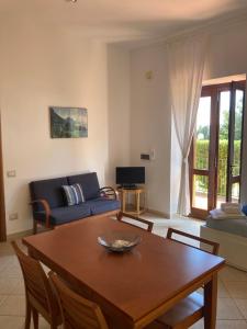 a living room with a table and a couch at Il Casalino in Maratea