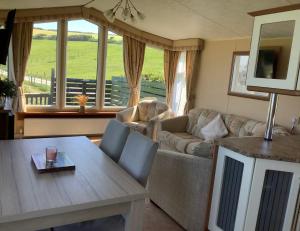 a living room with a couch and a table at Meadowview in Cardigan