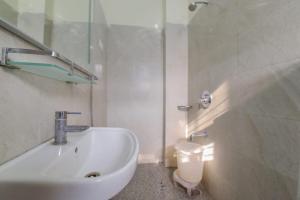 a white bathroom with a sink and a toilet at The experia Boutique in Jaipur