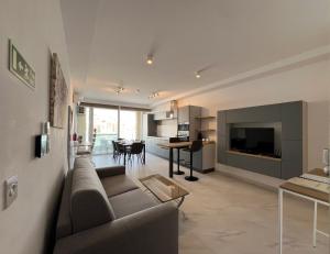 a living room with a couch and a dining room at Marina Bay in Marsaskala