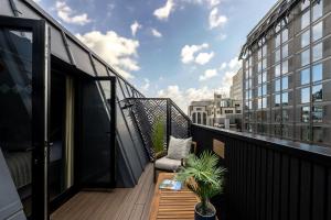 a balcony with a table and plants on a building at The Chamberlain in London