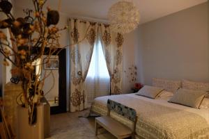 a bedroom with a bed and a large window at Le Gouzou in Tamarin