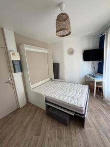 a bed in a room with a bed frame at La Capitane in La Baule