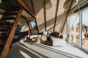 a living room with a couch and a table at Woodparadise in Nagyrada