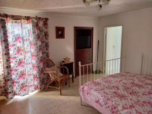 a bedroom with a bed and a dresser and curtains at Monolocali Tra Rieti e Terminillo e lago del Salto in Terminillo