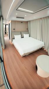 a bedroom with a large bed and a table at O'MIR glamping этно-отель Актау in Kyzylkum