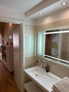 a bathroom with a sink and a mirror at Ibiscus apartment in Cagliari +26 photos