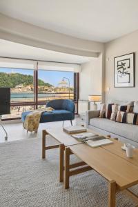 a living room with a couch and a table at Playa de La Concha 9 by FeelFree Rentals in Donostia-San Sebastián