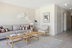 a living room with a couch and a table at Playa de La Concha 9 by FeelFree Rentals in Donostia-San Sebastián