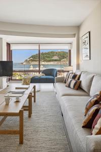 a living room with a couch and a table at Playa de La Concha 9 by FeelFree Rentals in Donostia-San Sebastián