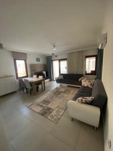 a living room with a couch and a table at Datça Gülce Apart in Datca