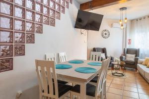 a dining room and living room with a table and chairs at Alojamiento el Campanario in Cazorla +31 photos