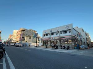 a city street with buildings and motorcycles parked on the street at 海洋星空民宿 in Magong