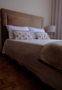 a bedroom with a large bed with pillows at Villa Baltazar in Vila do Conde
