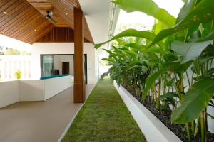 a hallway with plants in a house at Samui Paradise Poolside Villa in Nathon Bay