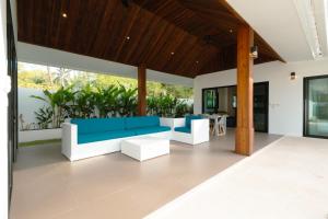 a living room with a blue and white couch at Samui Paradise Poolside Villa in Nathon Bay