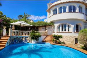 a house with a swimming pool in front of it at Villa Narby in Jávea