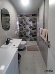 a bathroom with a toilet and a sink and a shower at ELEVEN in Šibenik