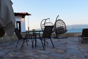 a table and chairs on a patio with a view at Elysian Blue in Petalidi