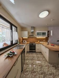 a kitchen with white cabinets and a sink and a window at Hiša Ana in Ankaran +41 photos