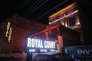 a royal court sign on the side of a building at night at The Royal Court in Ludhiana