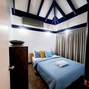 Un dormitorio con una cama grande con sábanas azules. en Mandurah Family Resort Bunkhouse, en Mandurah