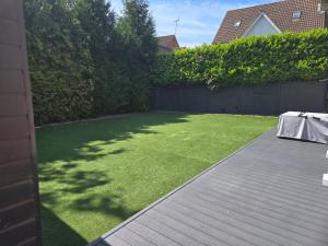 a backyard with a lawn with a table on it at Newly Built Studio Apartment in Weston