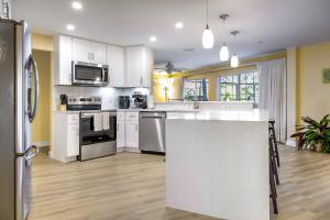 a kitchen with white cabinets and a white counter top at Family-Ready 4BR with Heated Pool & BBQ in North Fort Myers