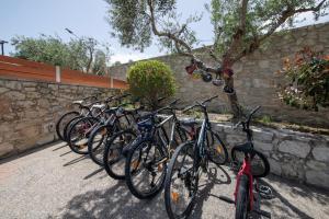 Une rangée de vélos garés à côté d'un mur de pierre dans l'établissement Roupes Villa II, Family villa, Fantastic views, Private pool, à Roúpai