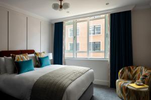 a bedroom with a large bed and a window at The Chamberlain in London +37 photos