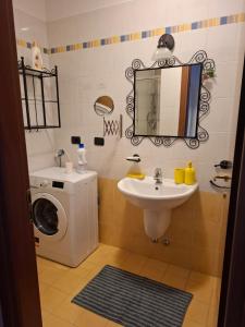 a bathroom with a washing machine and a sink at B&B Casa Fortunata in Milan