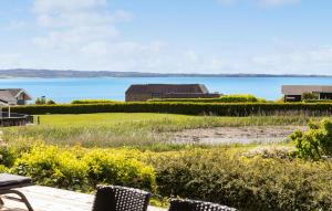 a view of the ocean from the deck of a house at Holiday Home Stenh in Rønde +23 photos