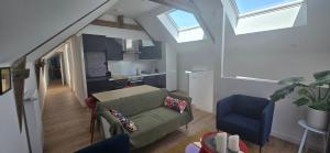 a living room with a couch and a kitchen at Gîte avec sauna in Vigneux-de-Bretagne