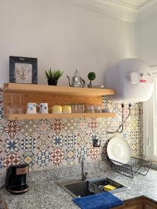 a kitchen with a sink and a tile wall at Julie's AIRPORT Apartment in Marrakesh